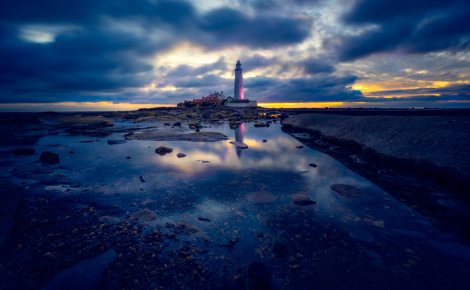 lighthouse under gray clouds